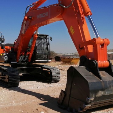 Two people on mine site looking at machines